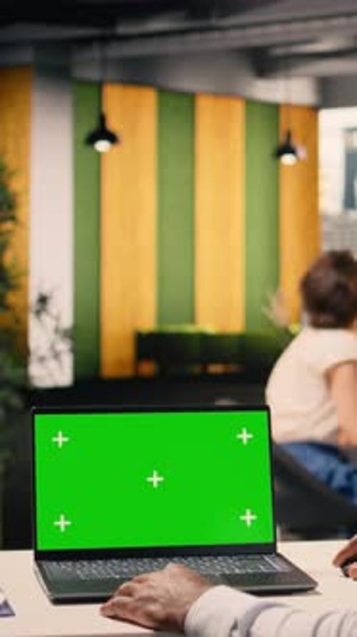 Vertical Video Green Screen Mockup with Black Man Sitting at Business Office Desk