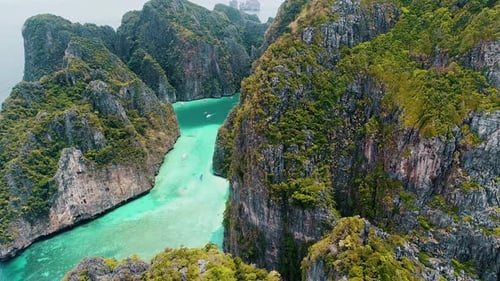 Aerial view of iconic tropical turquoise water Pileh Lagoon surrounded by limestone cliffs, Phi Phi