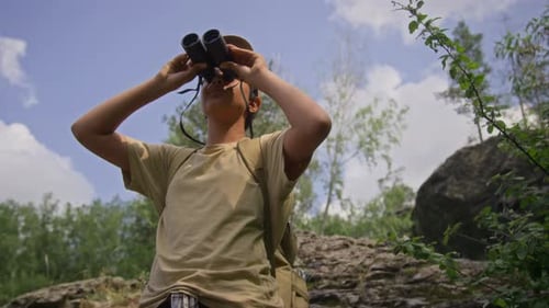 Boy and Man Hiking and Using Binoculars