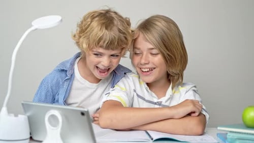 Middle Primary School Students Boy Girl Remotely Studying Writing Book Homework and Tablet at Class