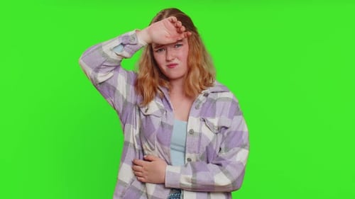 Young Adult Female Coughing Against Green Background