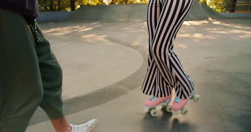 Woman Learns to Skate with Friend in Skatepark