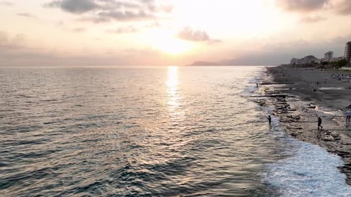 Aerial View Sunlit Shoreline Mediterranean Beach at Sunrise