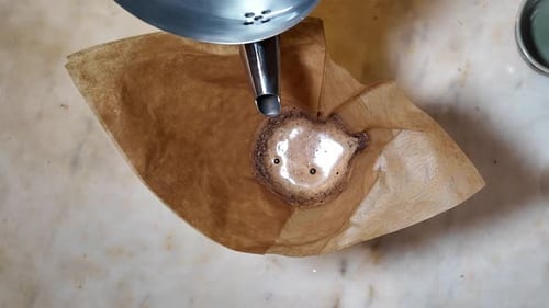 Pouring Water Into Coffee Filter with Grounds