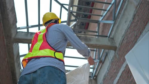 Portrait of engineers inspect and assess the residential home construction site's progress