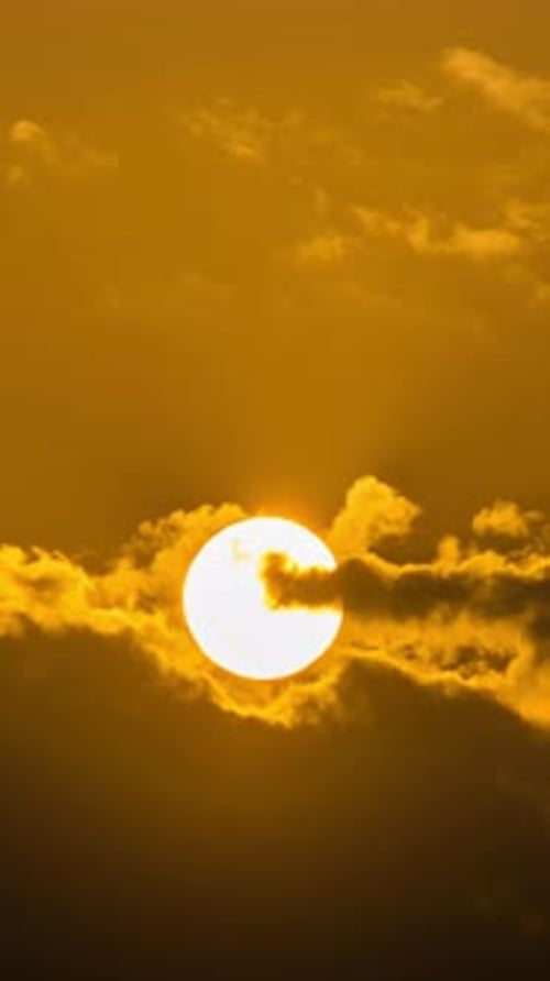 Golden Sun Rises Through Clouds in Time-Lapse