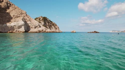 Clear turquoise water and rocky coast under blue sky in Cephalonia island Greece