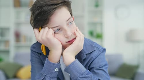 Bored schoolboy do task Tired exhausted sad upset fatigued little child boy kid pupil schoolboy