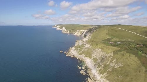 Cornwall aerial drone view of seaside rocky cliffs and turquoise water
