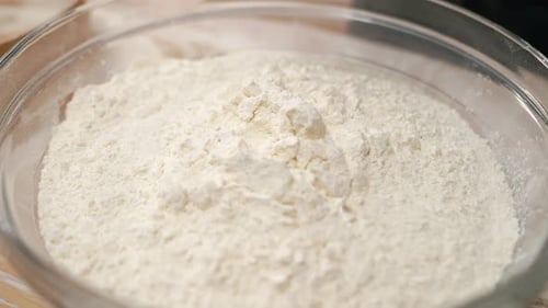 Yellow Egg Falls Into Flour