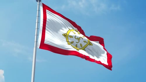 Waving Buddhist Flag with Dharma Wheel Symbol in Blue Sky