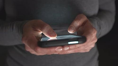 Close-up of a woman's fingers using the screen of a mobile phone, smartphone.
