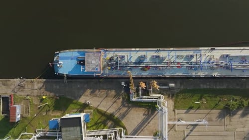 Aerial view of tanker vessel loading fuel at oil terminal operations