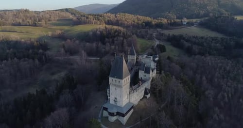Orbiting Drone Shot of a Castle on a Mountain at Sunset in Austria, 4k UHD