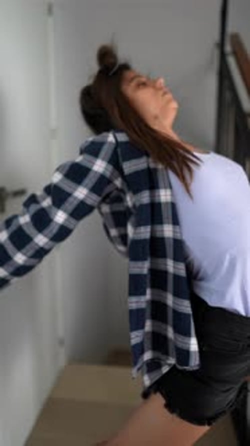 Girl Dancing and Stretching in Hallway