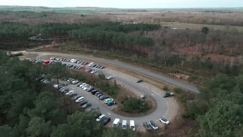 Cars parked in parking in rural area. Aerial forward