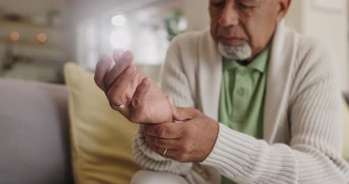 Senior Adult Holding His Wrist in Pain
