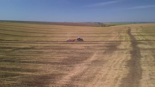 Tractor working on the field doing tillage with cultivator