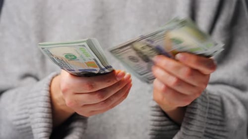 Close Up of Woman Counting US Dollar Bills