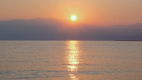 Sunrise on the beach. Sea. Sunlight and sun ray reflect on water surface
