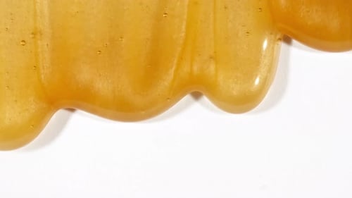 Yellow Cosmetic Gel Fluid With Molecule Bubbles Flowing On The Plain White Background Liquid Cream