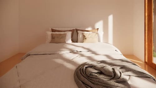 Cozy bedroom with white bed and brown blanket