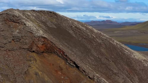 Aerial drone view of the highlands reveal from behind mountain, Iceland