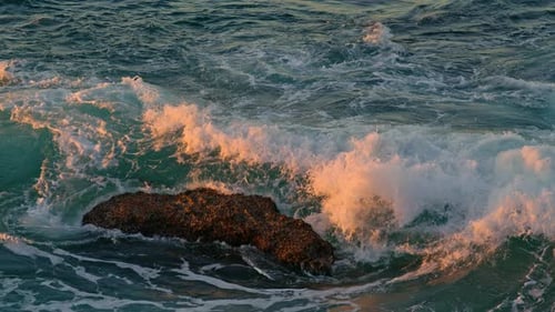 High Waves Rolling Dark Rocks in Sunlight Nature Close Up. Scenic Seascape