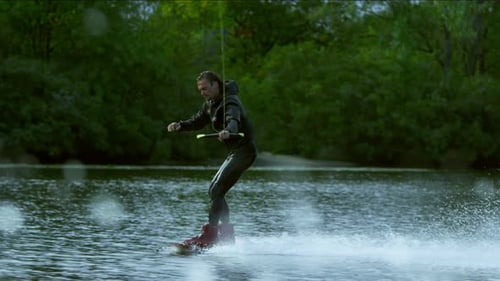 Wakeboarder enjoying extreme watersport action on a sunny river adventure