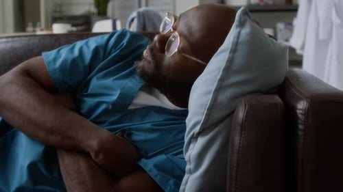 Medical Professional Relaxing on Couch During Break