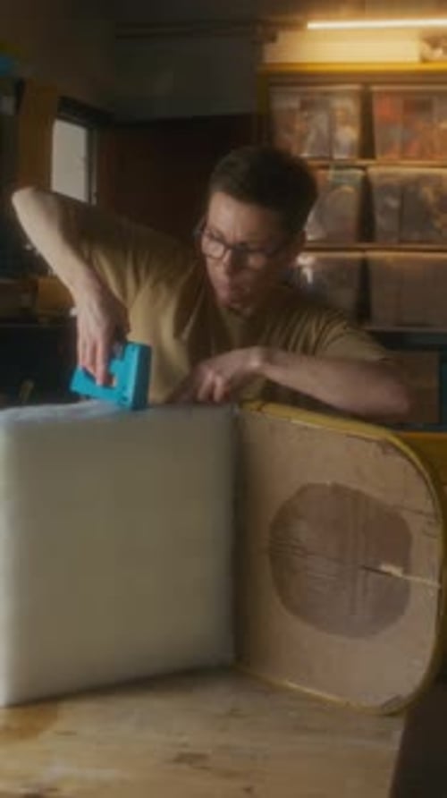 Young Adult Working with Staple Gun on Project