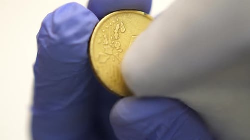 Isolated close shot of front fifty cent euro coin wiped, corruption concept