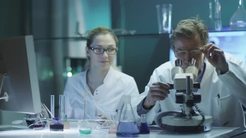 Professor and Student Girl are Doing Chemical Researches in Laboratory.mov