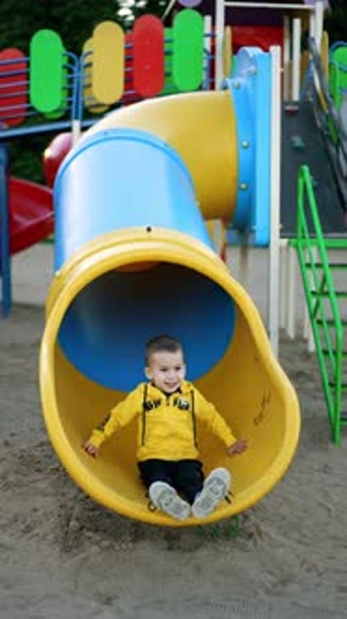 Child Enjoys Playground Slide, Runs Up Stairs