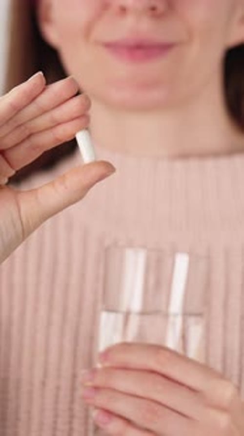 Woman Holding Magnesium Capsule With Water Daily Relaxation Supplement