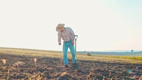 Natural Organic Soil Agriculture Man Farmer Touching Ground on Field Farmer Holding and Pouring Back