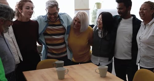 Happy Multi-Generational Group Smiles Around Table