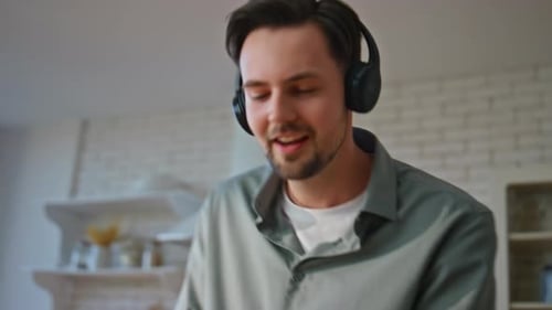 Man With Headphones Dances While Cooking at Home