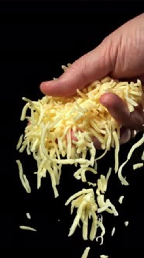 Grated Cheese Falls Out of the Cook's Hand Filmed on a Highspeed Camera at 1000 Fps