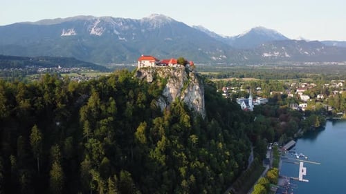 AERIAL Orbiting Shot of Bled Castle in Lake Bled. Slovenia on a Sunny Summer Day