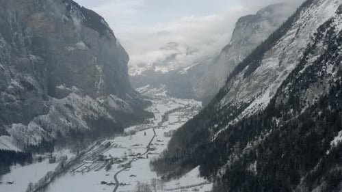 Drone Aerial of Lauterbrunnen surrounded by the Mountain Eiger in the swiss alps. The winter in Swit