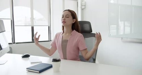 Mindfulness practice at office desk corporate environment lifestyle content calmness viewpoint