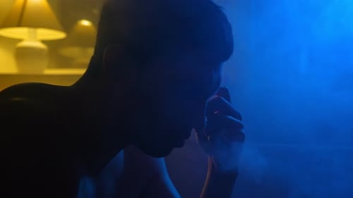 Sad Man Smokes an Electronic Cigarette and Suffers From Depression Night in Dark