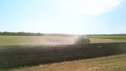 Tractors plowing the field in Ukraine