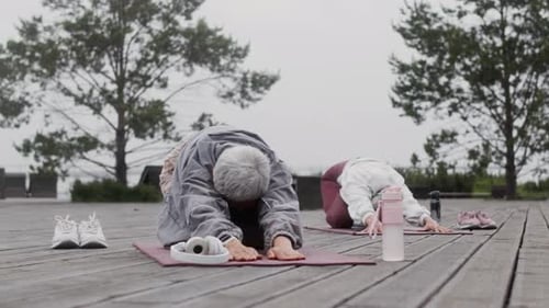 Women Stretching in Yoga Poses Outdoors