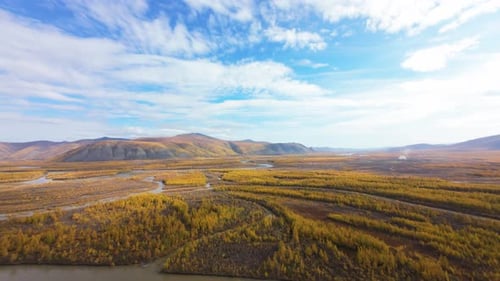 Experience breathtaking aerial views capturing vibrant autumn colors over river valleys and rolling