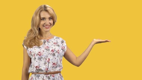 Happy Caucasian Woman Shows Copy Space Left Hand