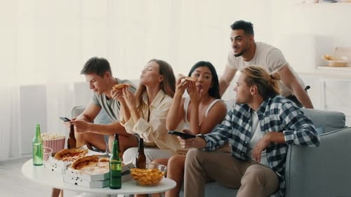 Friends Enjoying a Fun Night Together at Home with Food and Laughter