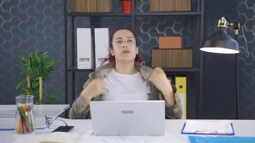 Woman Feeling Overheated While Working at Laptop