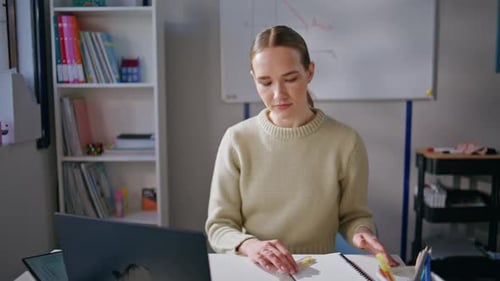 Female Working at Laptop in Office Environment